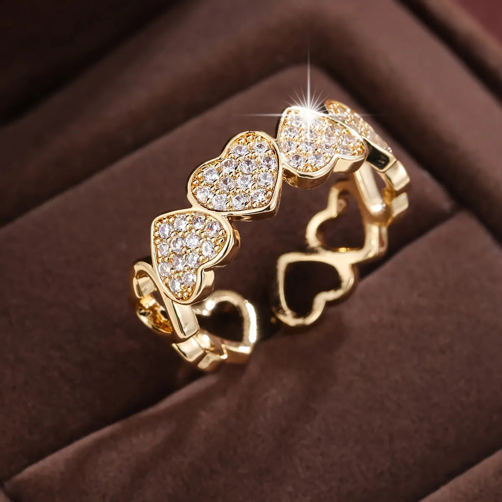 Adjustable copper fashion ring with a heart design, shown in gold and silver colour options.