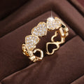 Adjustable copper fashion ring with a heart design, shown in gold and silver colour options.