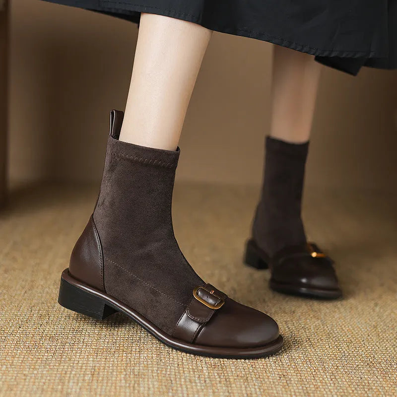 Women's black casual martin boots with belt buckle stitching, lace-up front, and a low rubber sole.