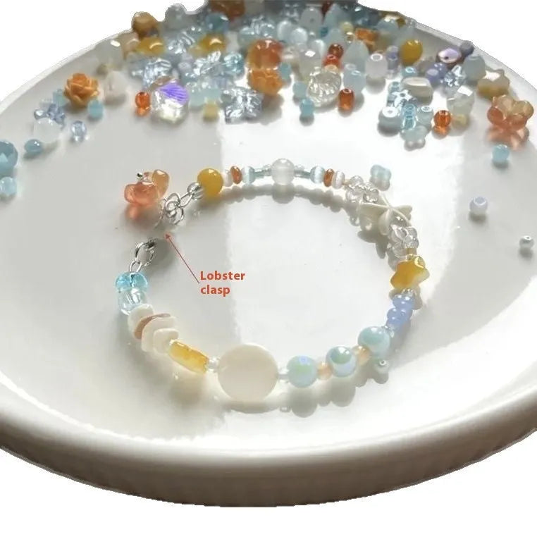 Diamond-shaped mixed-material bracelet for women in orange and sea summer colours with round design elements.