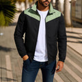 Man wearing a green windproof jacket with a high collar and colour-matched front zipper.
