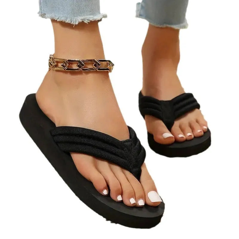 Black women's flat slippers with cotton upper, ribbon detail, and EVA sole.