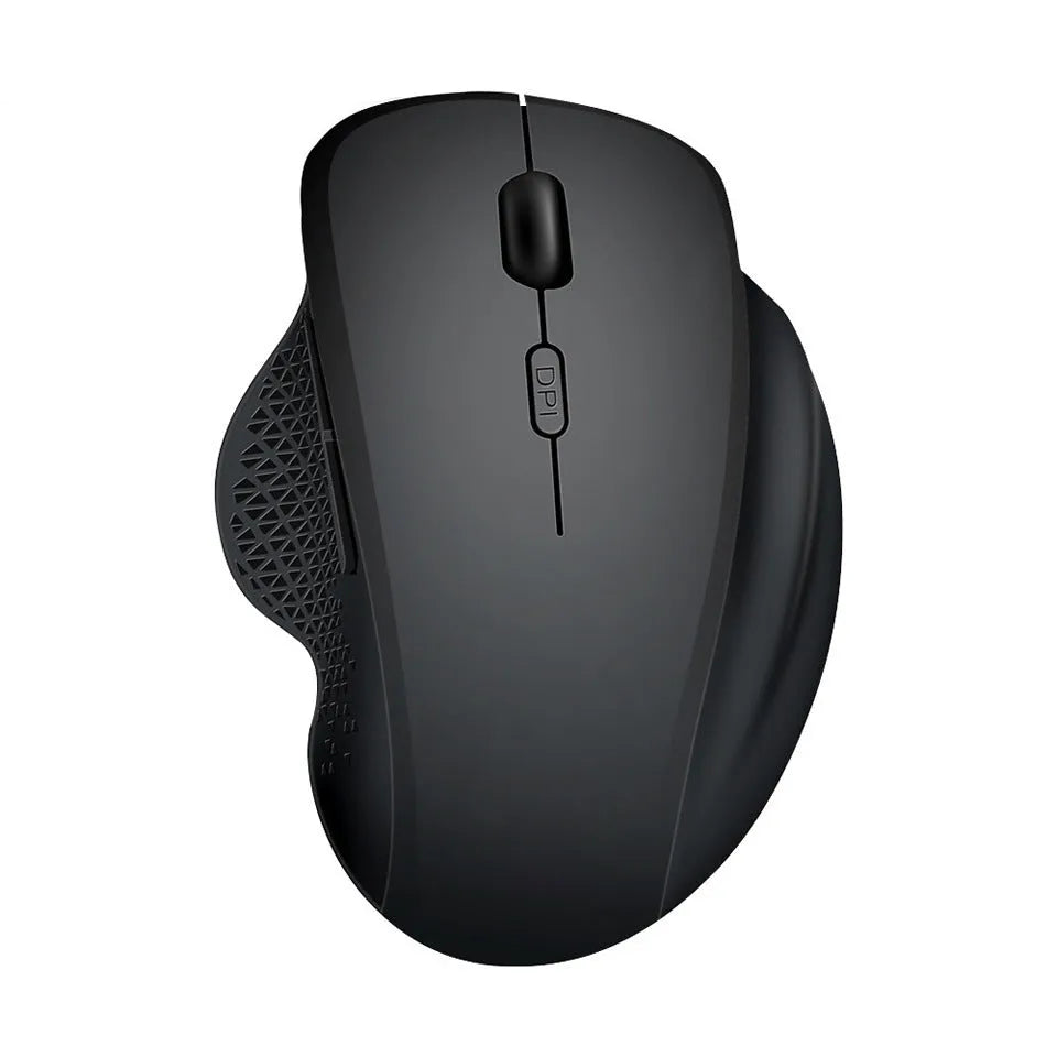 Grey wireless optical mouse with USB charging cable next to laptop computer