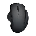 Grey wireless optical mouse with USB charging cable next to laptop computer