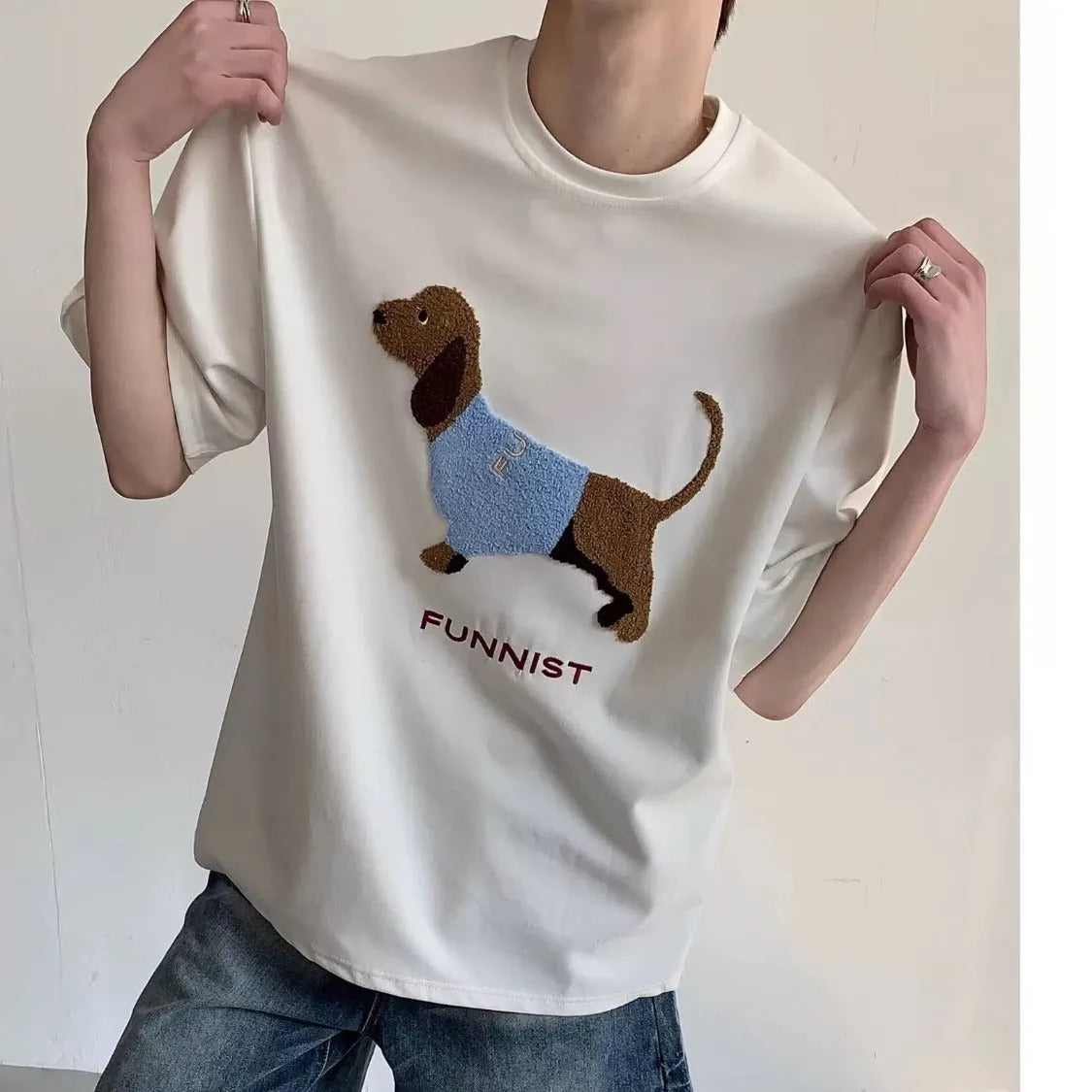 Men's grey cotton T-shirt with an embroidered sausage dog on the chest, showing short sleeves and a round neck.