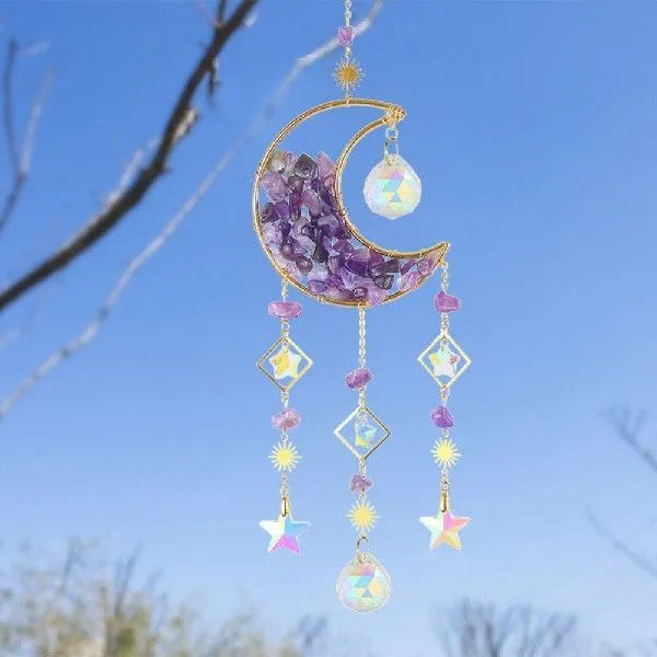 K9 crystal moon-shaped pendant on a cord for hanging in a car interior.
