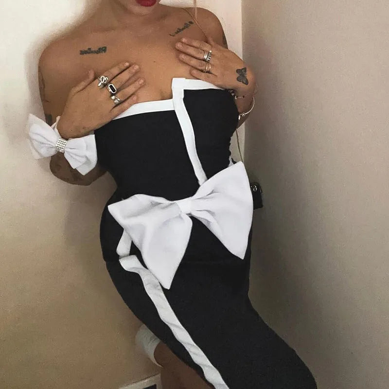 Black and white colour-block women's swimsuit with asymmetric tube top and bow detail