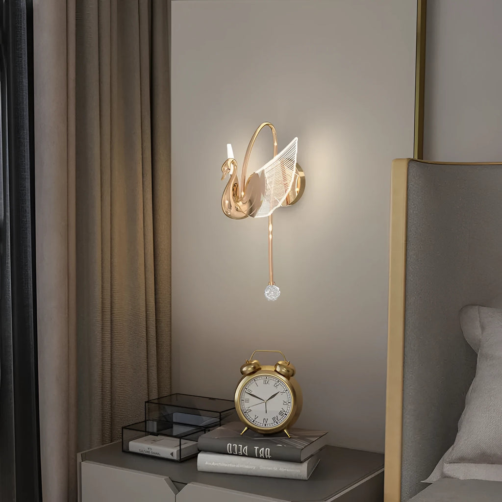 Gold-coloured modern swan-shaped wall lamp with acrylic shade and dimmable multi-colour LED light.