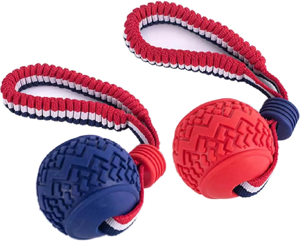 Red rubber dog ball with rope attachment showing textured surface and 29cm total length