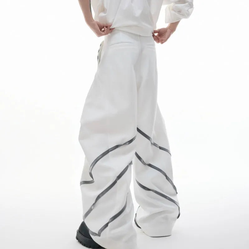 Men's black polyester trousers with metal striped rivet details and pleated front.