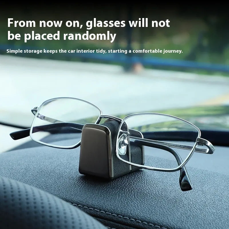 Zinc alloy and leather car dashboard glasses clip holder in green, shown on a car dashboard.