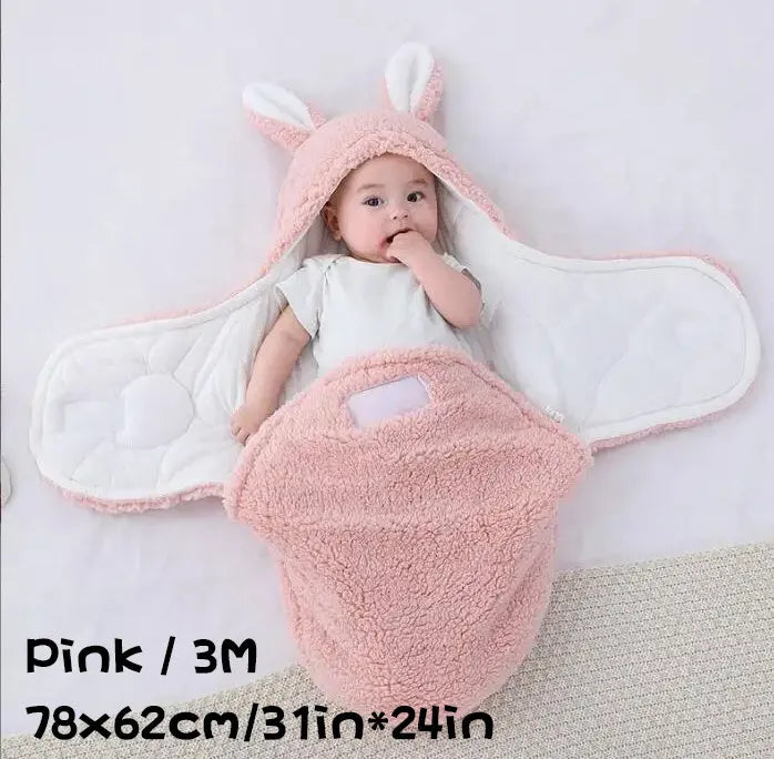 A baby wearing a soft grey fleece sleeping bag with hook-and-loop shoulder straps.