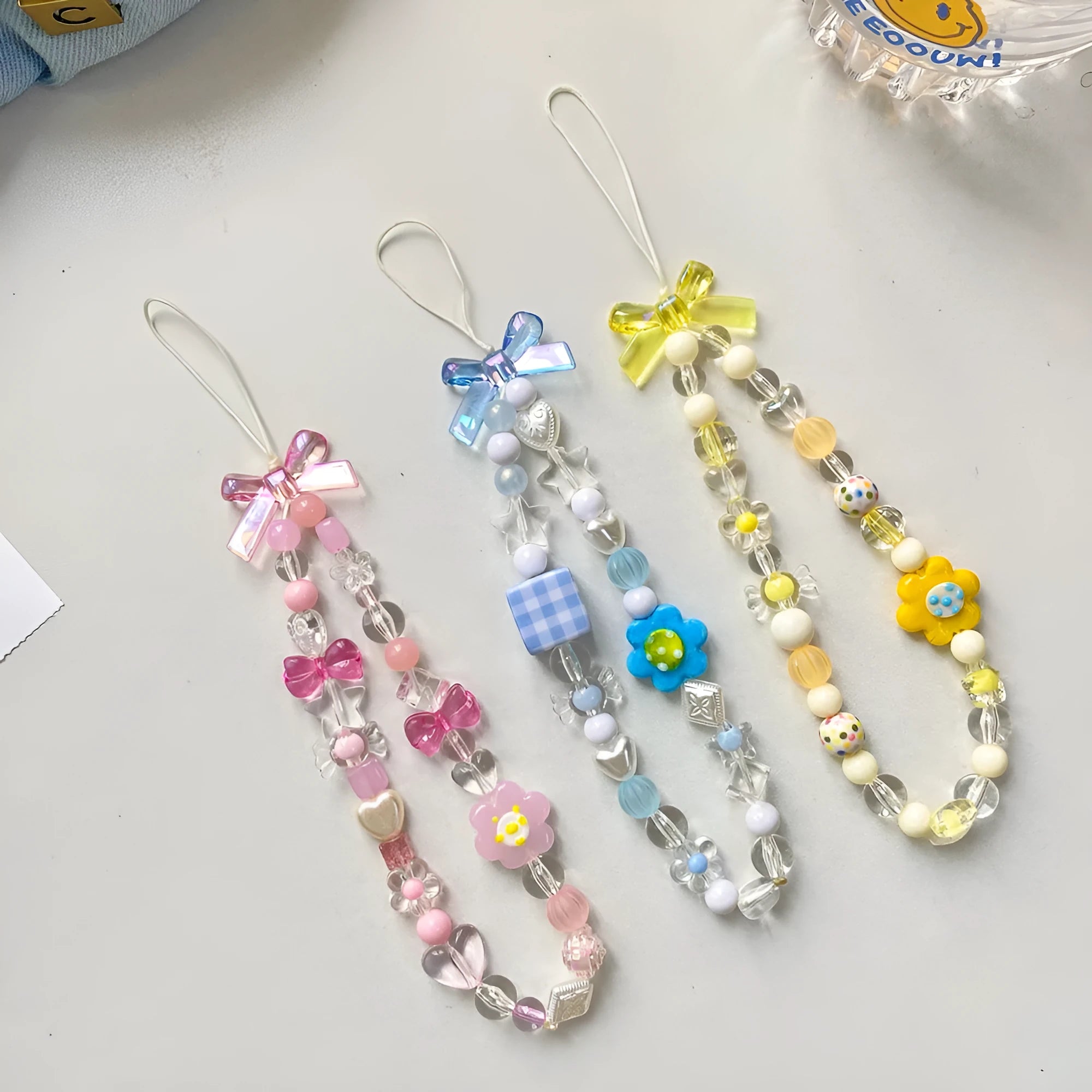 Close-up of a blue flower beaded phone lanyard with a rope strap for carrying mobile phones.