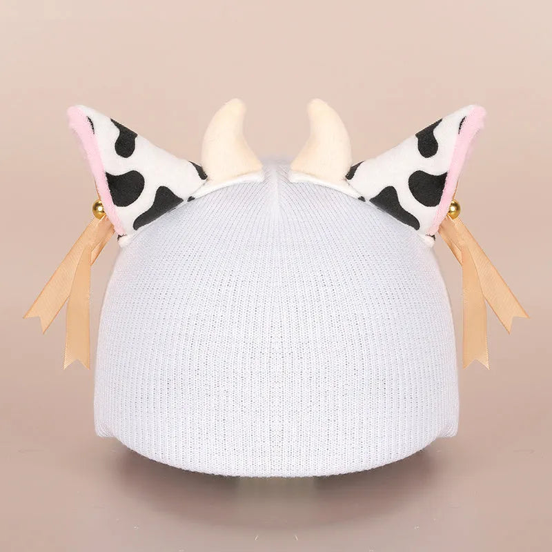 Soft plush cartoon character cover on a motorcycle helmet, showing size M and decorative ear sections.