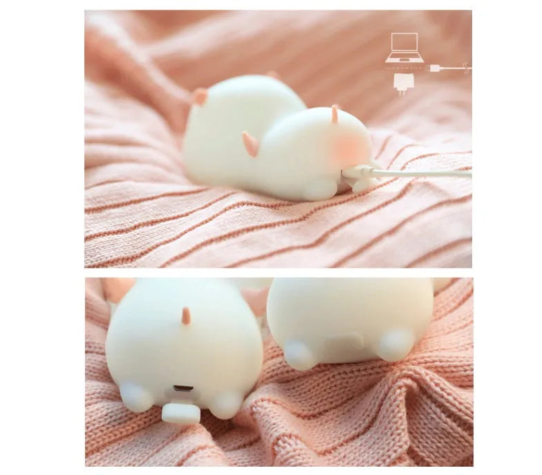 Blue silicone pig-shaped night light with USB charging port