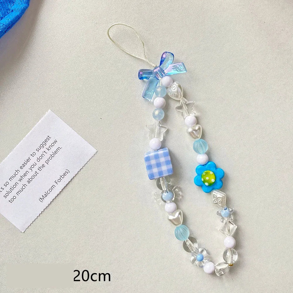 Close-up of a blue flower beaded phone lanyard with a rope strap for carrying mobile phones.