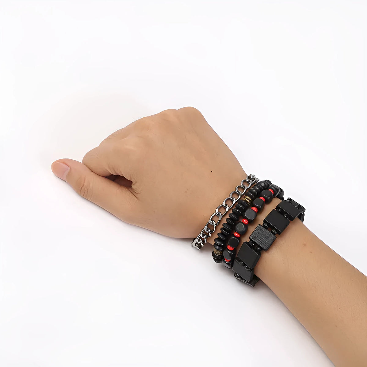 Set of four handmade retro woven alloy bracelets in different colours on a neutral background