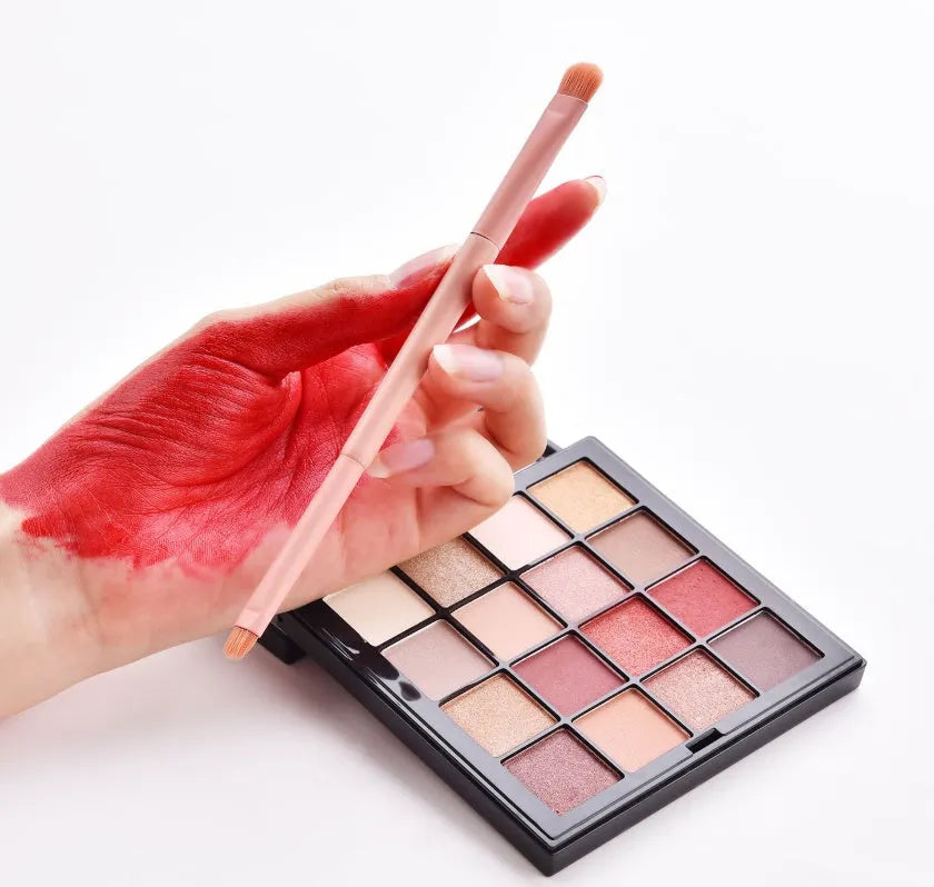 Ten professional makeup brushes with wooden handles including powder, foundation, and double-ended brushes.