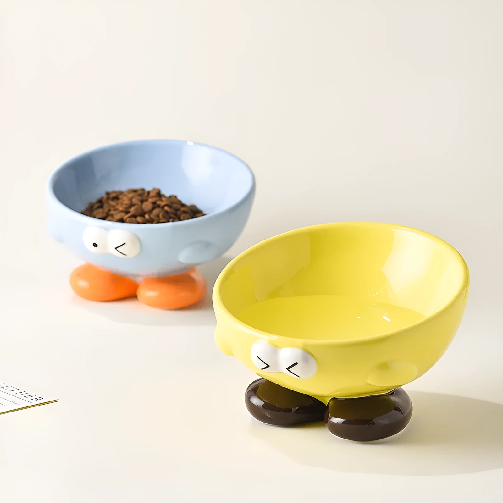 Ceramic slanted pet bowl in blue colour showing oblique design for neck support during feeding