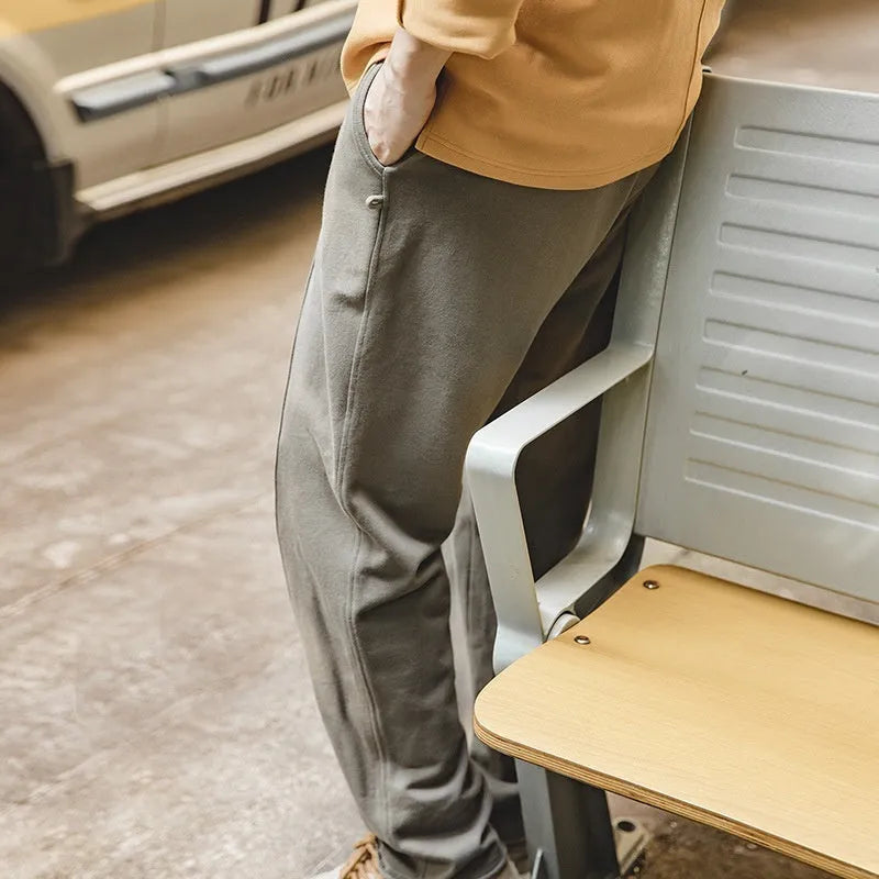 Men's cotton knitted sweatpants in olive green with tapered 3D cut hemming, straight leg retro style