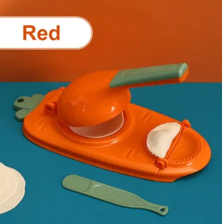 Orange and white manual kitchen dumpling press tool with ergonomic handle on wooden table