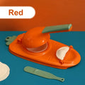 Orange and white manual kitchen dumpling press tool with ergonomic handle on wooden table