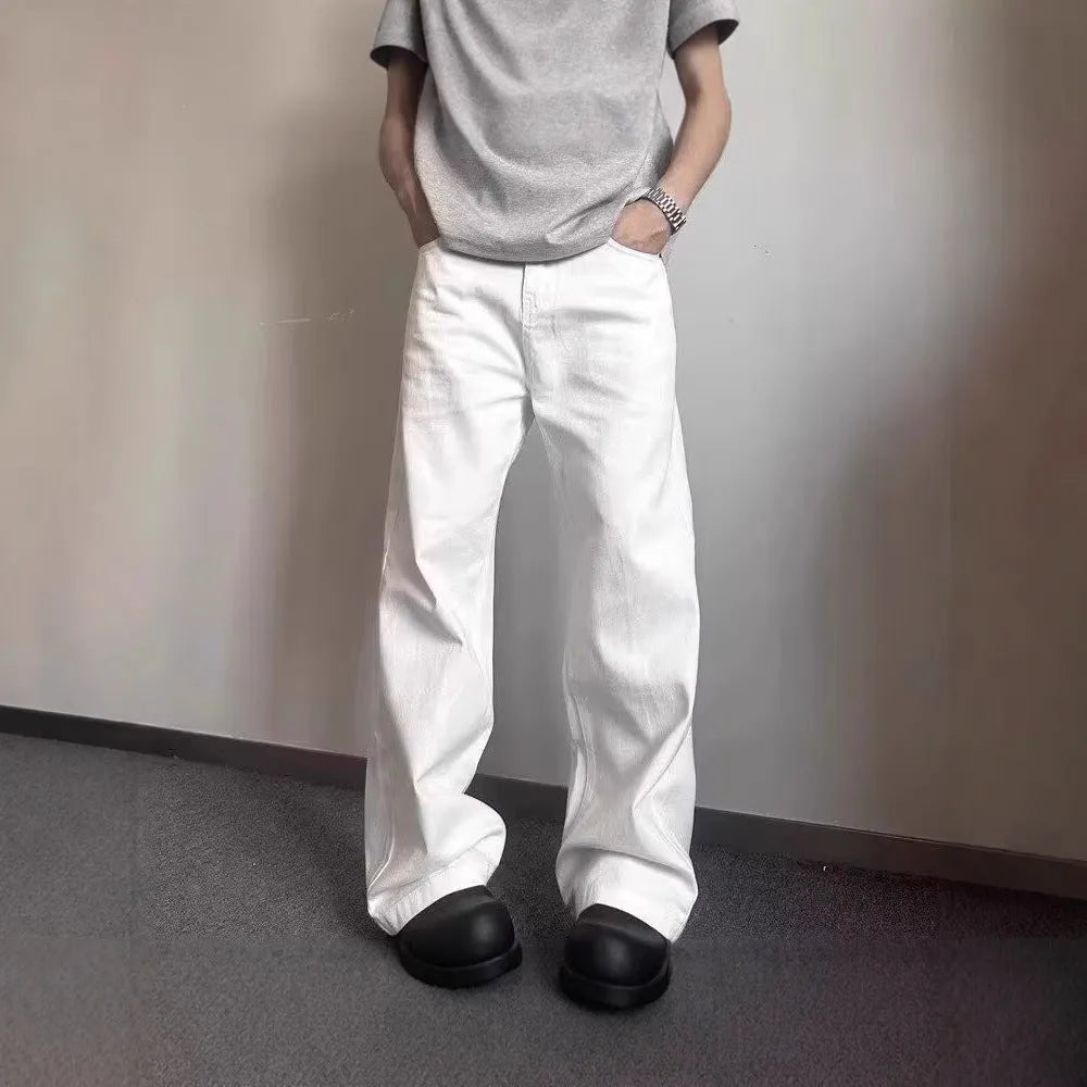 Men's loose straight wide leg white cotton denim jeans on a plain background