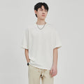 Men's brown drape knit loose fit T-shirt with short sleeves on hanger