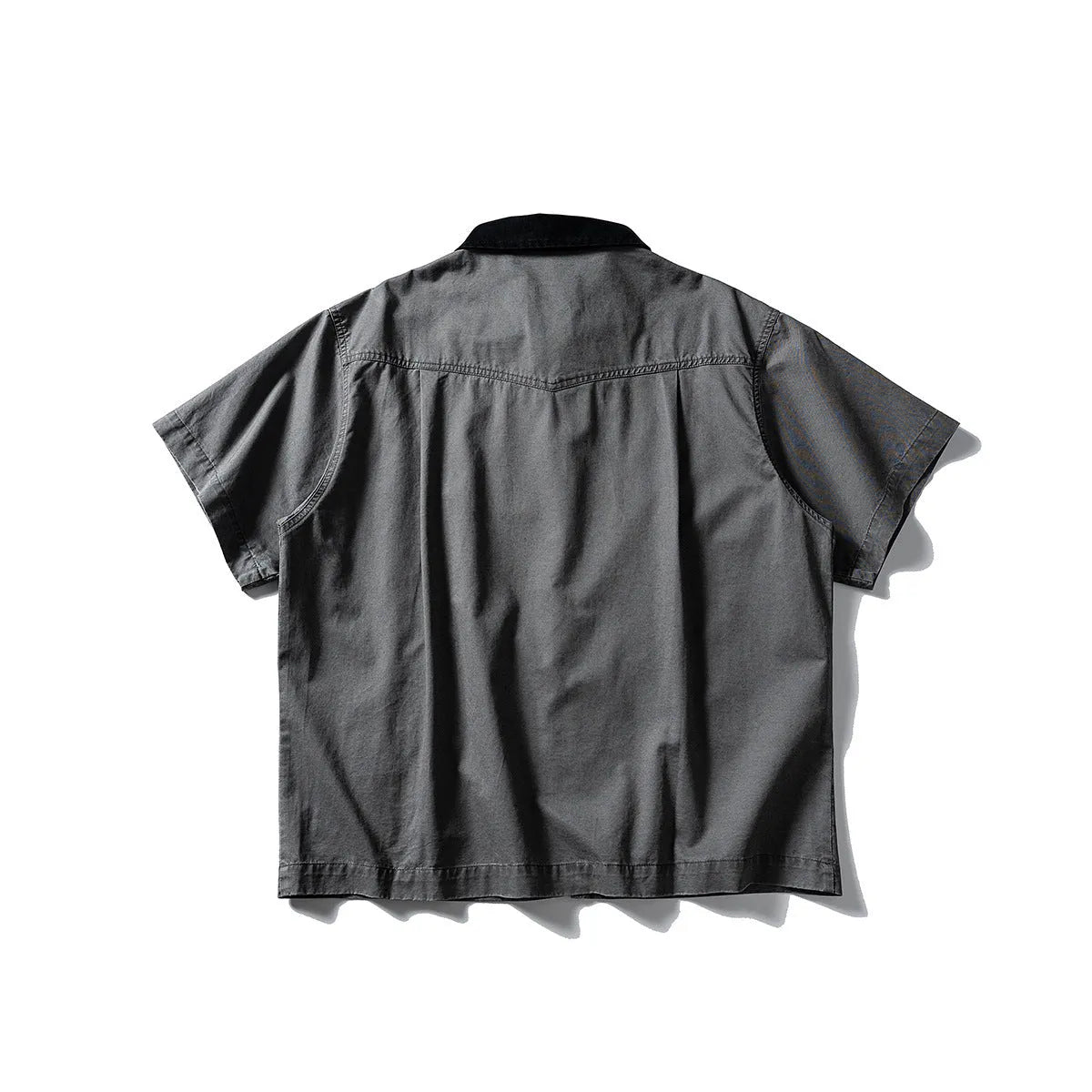 A khaki-coloured, loose-fitting, short-sleeved cotton shirt styled as washed overalls for teenagers