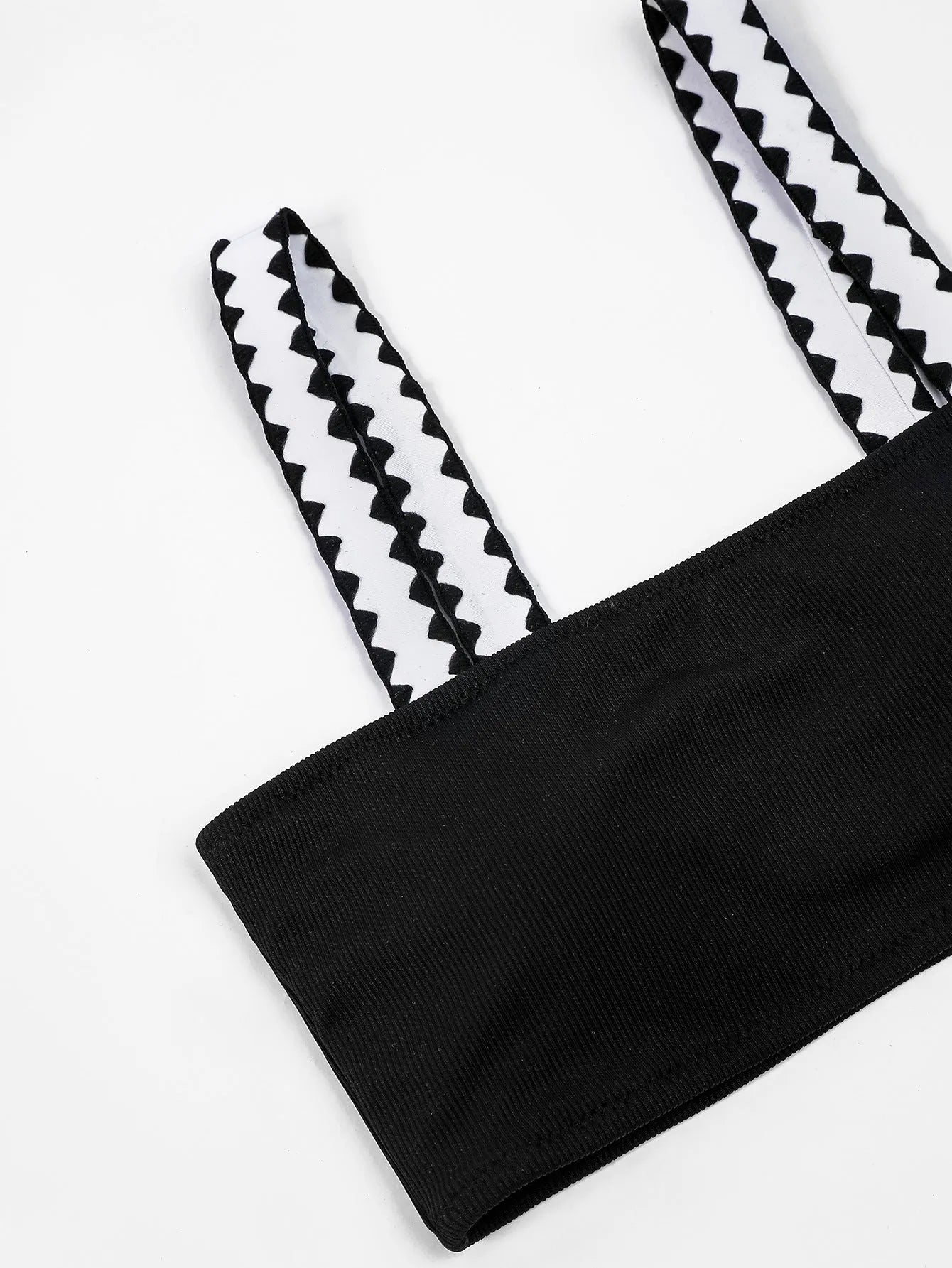 Black women's bikini swimsuit with a hollowed-out split design and brief style.