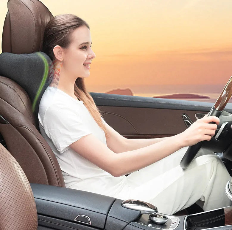 Dark grey memory foam car headrest pillow shown on car seat, measuring 67x10x27.5 cm.