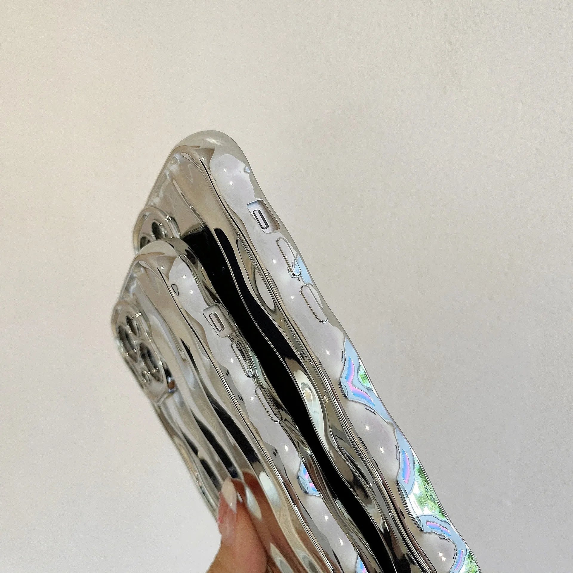 Electroplated 3D wave stripe protective case for iPhone 17 Pro Max in silver finish.