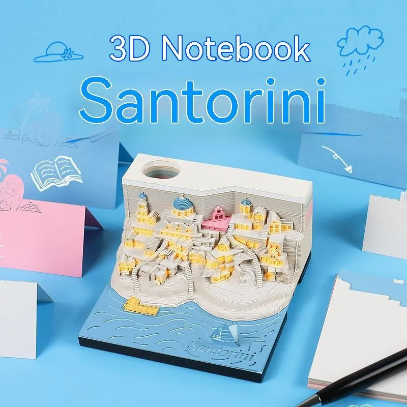 Assembled Santorini beach 3D paper model notepad with decorative lighting on a desk.