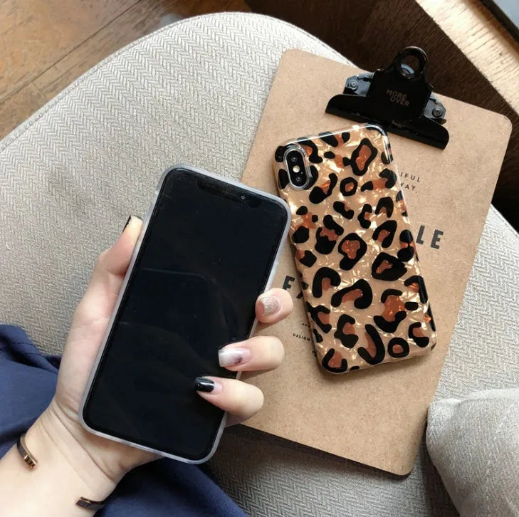 Leopard print patterned silicone phone case for iPhone on a table