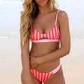 Women's polyester bikini swimsuit in black and white dots or red and white stripes pattern.
