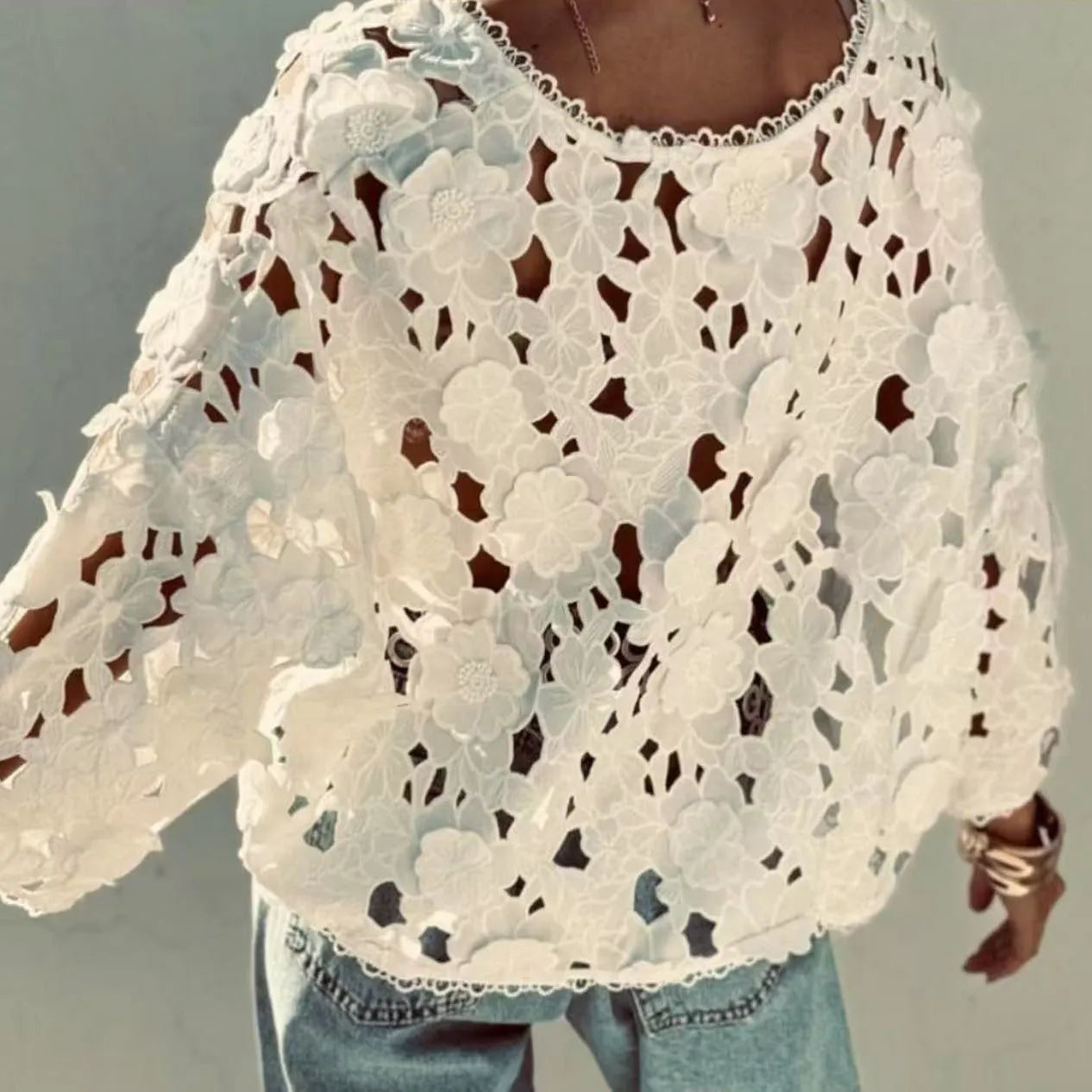 Women's loose-fitting lace cardigan with 3D floral decoration and V-neck in black.