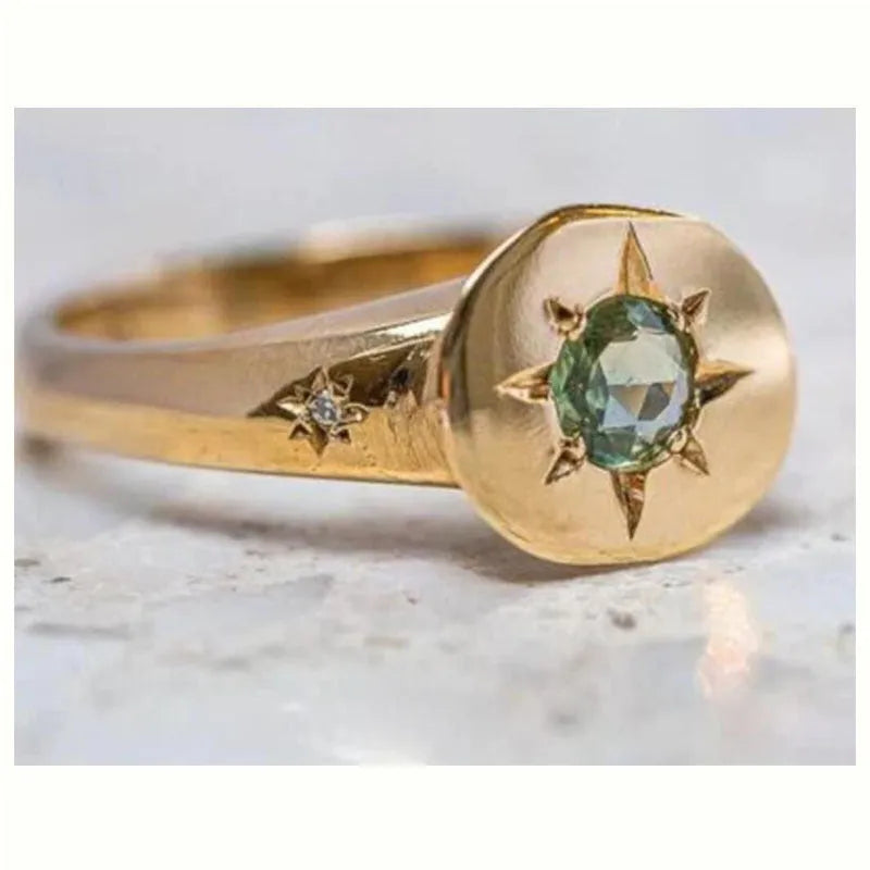 Golden zinc alloy ring with an adjustable opening and a star-shaped zircon asterism design.
