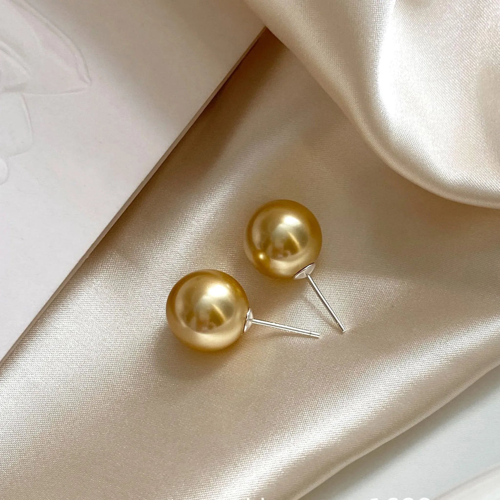 Women's geometric pearl stud earrings with silver settings and retro styling