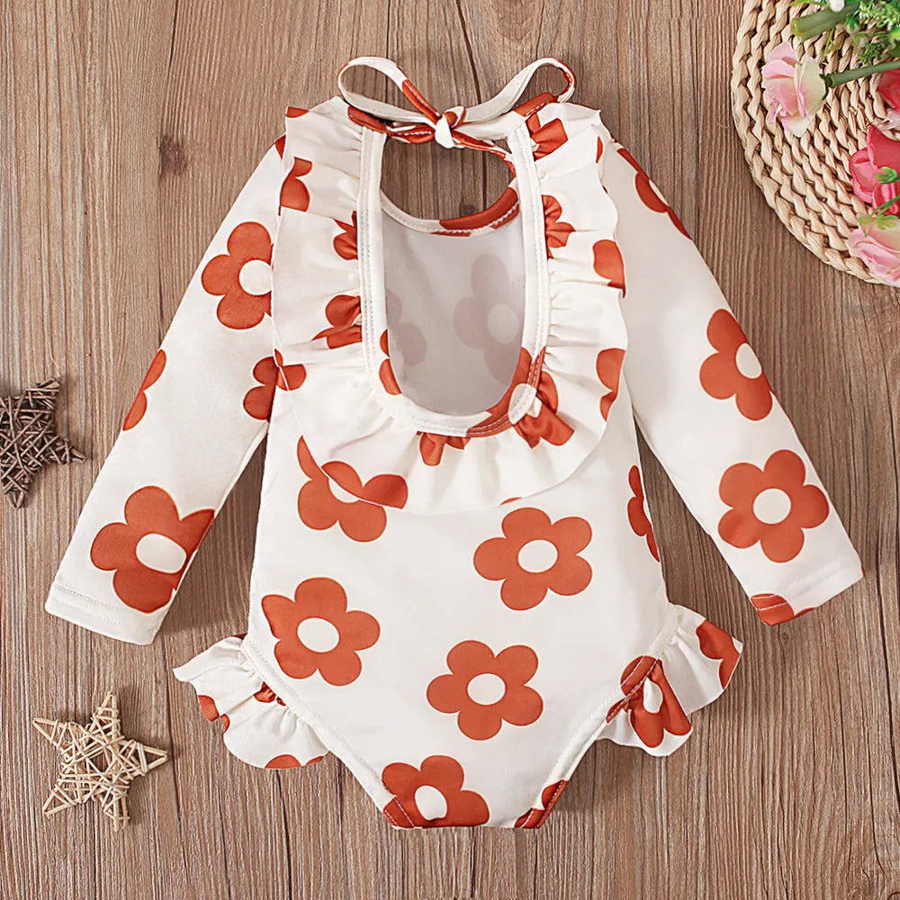 Girl's floral pattern swimsuit with crew neck and open back design in polyester fabric