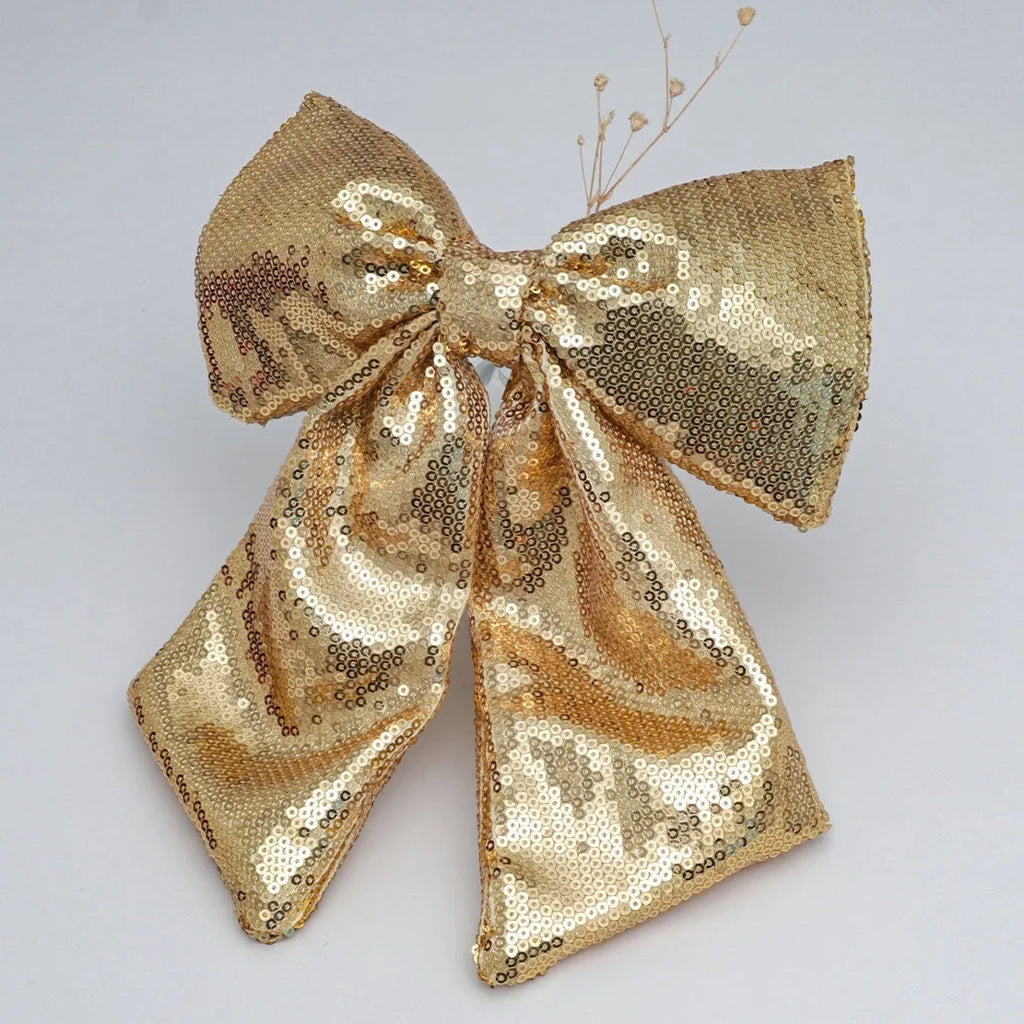 Pearlescent sequined Christmas bow decoration in gold, red, or silver, available in 20X25, 25X30, and 35X40 sizes.