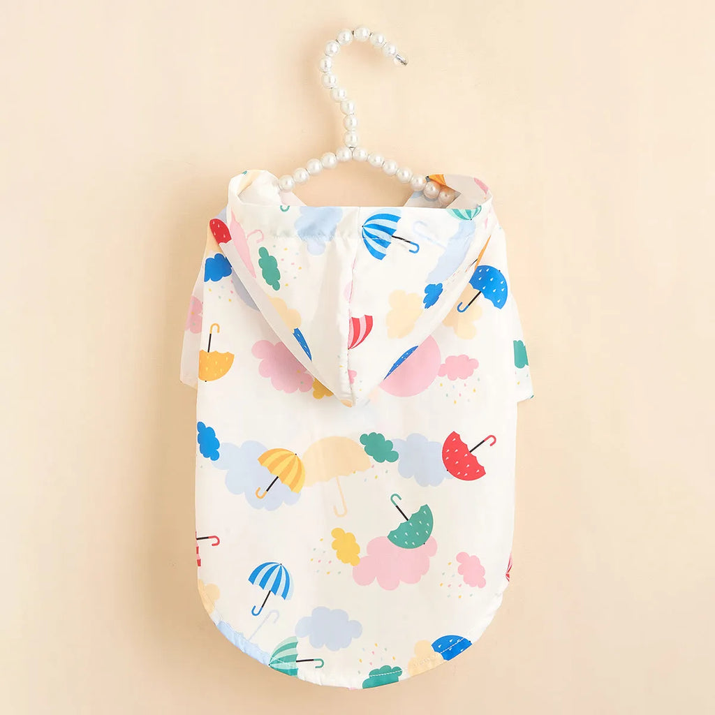 Colourful cartoon umbrella pattern dog raincoat on a model, showing the polyester fabric and size options.