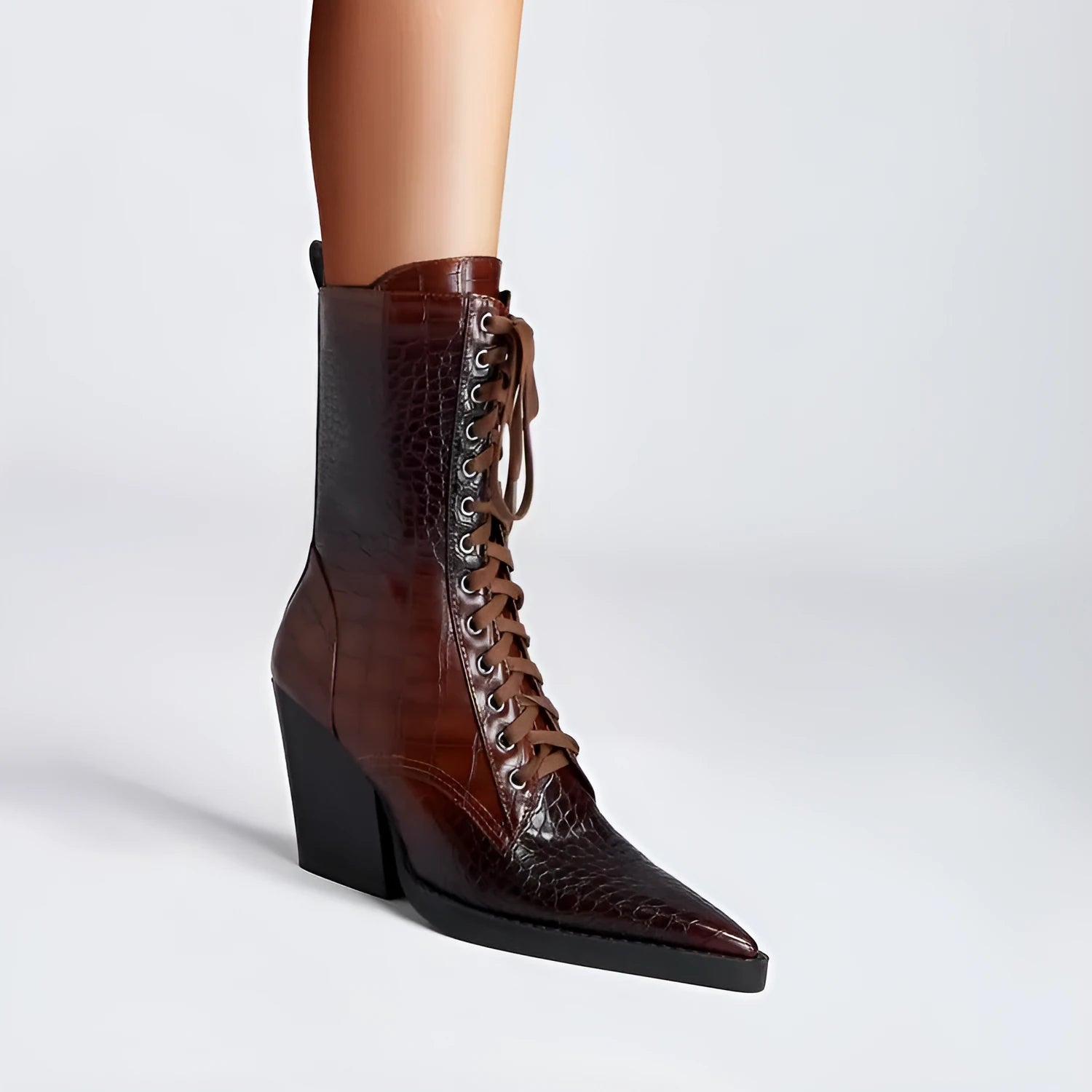Dark brown retro pointed toe ankle boots with lace detailing and a chunky heel on a white background.
