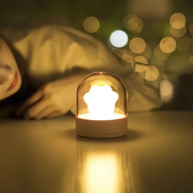 Grey or pink cat paw shaped USB rechargeable night light with rotating soft light and music box feature