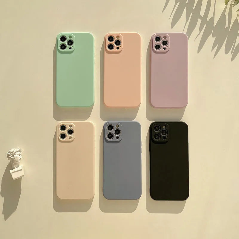 Frosted matte silicone phone case for iPhone 14 on a table, showing the slate blue colour option.