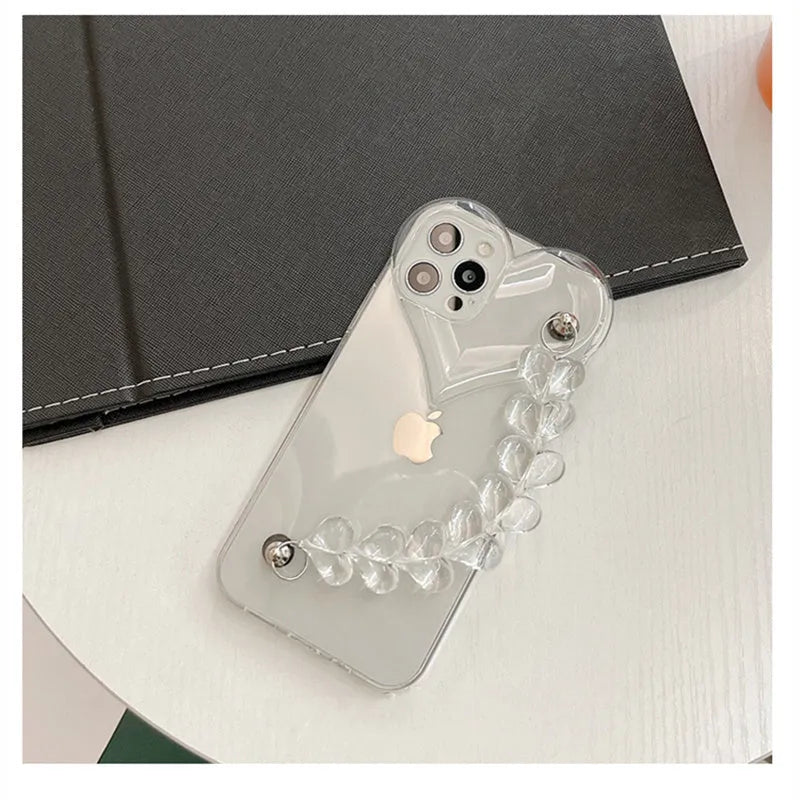 Transparent soft TPU iPhone case with a built-in clear love heart charm and chain.
