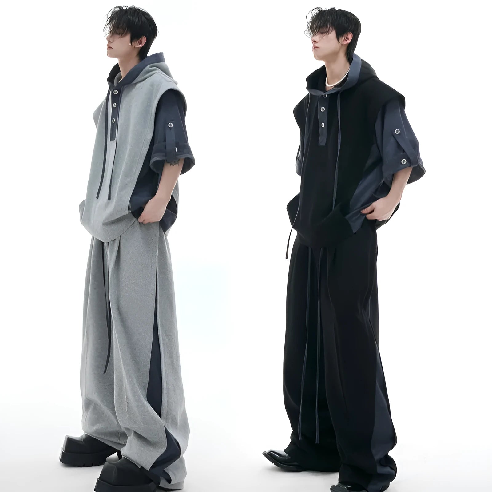 Man wearing a grey hooded short-sleeve sweatshirt and matching trousers with three-dimensional stitching detail.