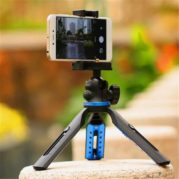 Black desktop tripod holding a mobile phone, showing adjustable bracket and plastic-aluminium construction