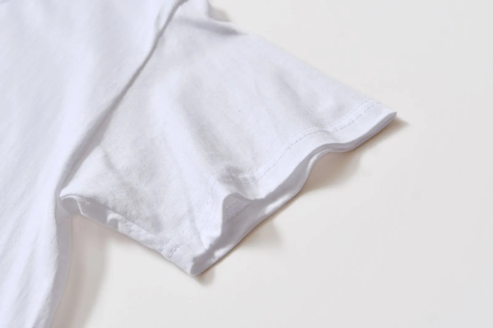 White cotton denim overalls with round neck and short sleeves, loose fit pullover style