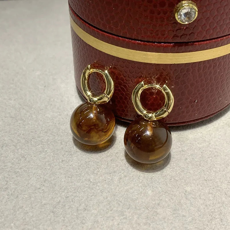 Simple Retro amber resin drop dangle earrings Style1, lightweight, approx 3.5 cm length, warm translucent colour, on neutral background