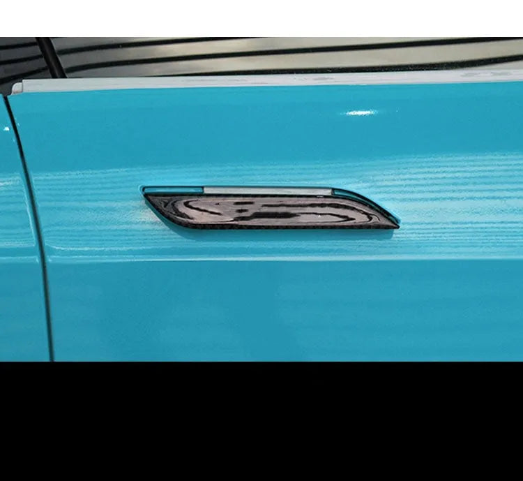 Four clear carbon fibre adhesive door handle protection patches for Tesla Model S interior.